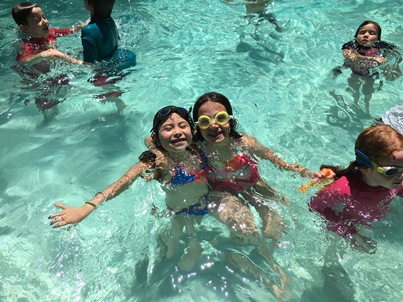 Avery and Mila swimming