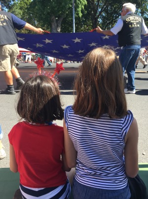 girls watching 4th of July parade