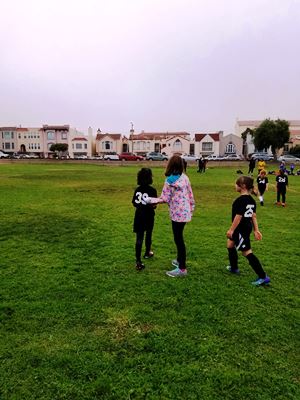 sisters-on-soccer-field